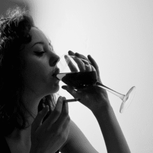 black and white photo of woman drinking glass of wine
